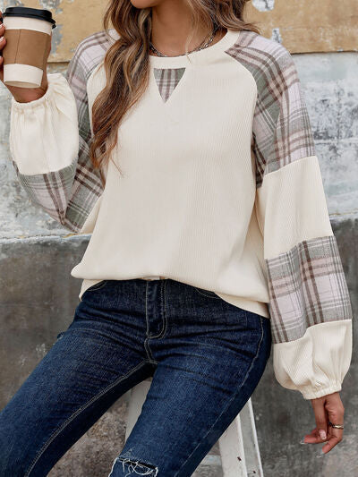 Perfee plaid round neck long sleeve sweatshirt worn by woman, showing plaid pattern and casual style.