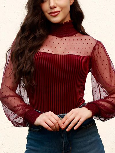 Smocked mock neck long sleeve bodysuit with lace detail and semi-sheer design.