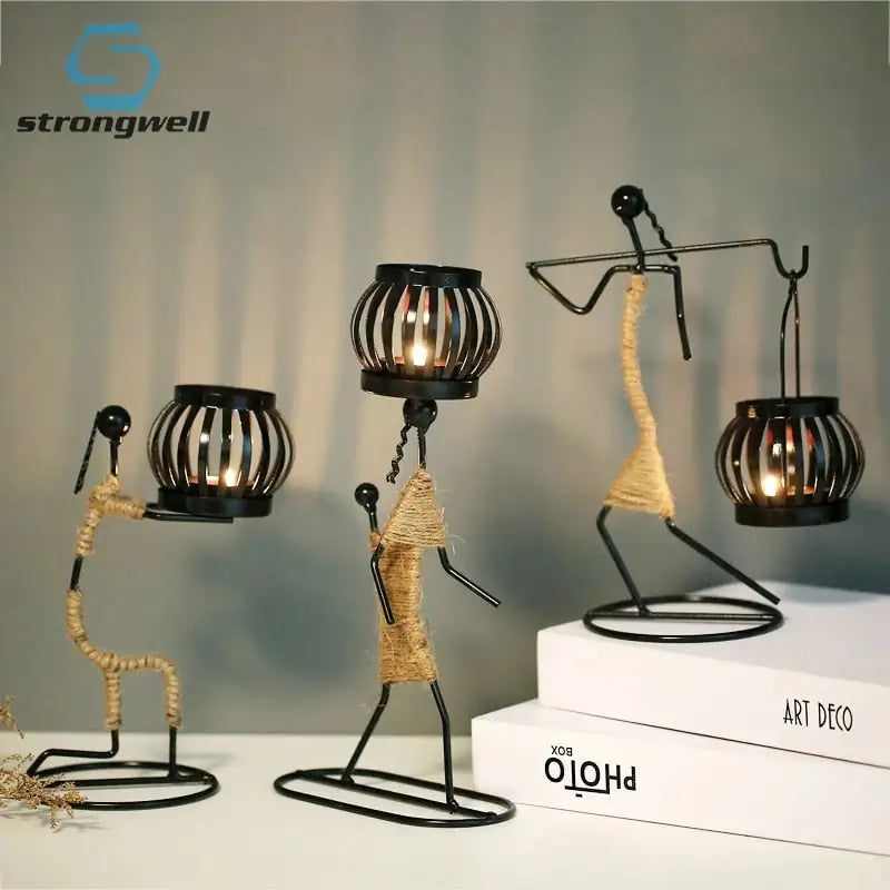 Nordic Metal Candlestick Abstract Character Sculpture Candle Holder on table with books.