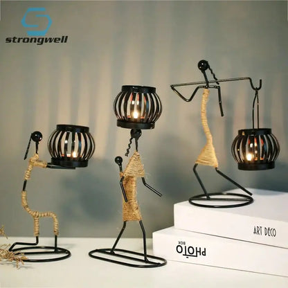 Nordic Metal Candlestick Abstract Character Sculpture Candle Holder on table with books.