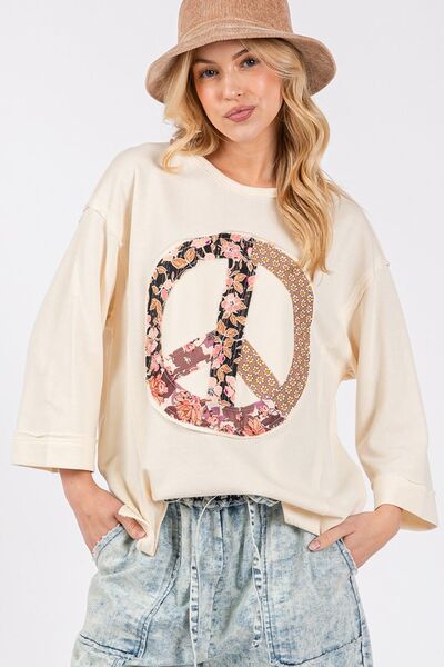 SAGE + FIG Floral Peace Patch Round Neck Top with floral design.