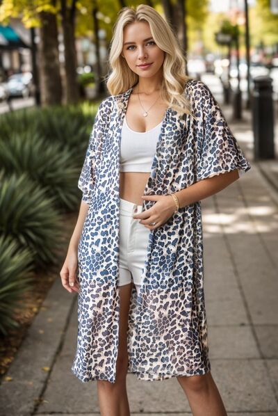 Heimish Full Size Leopard Open Front Cardigan Plus Size worn casually outdoors.