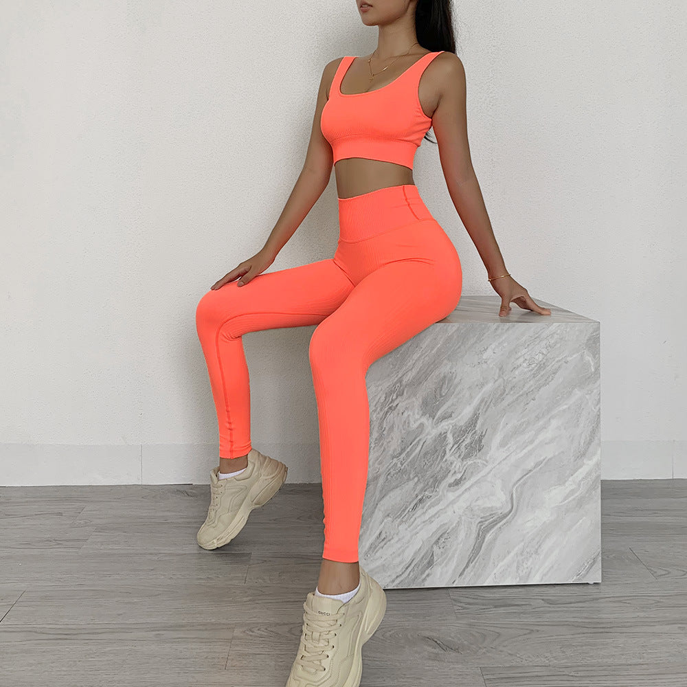 Bright orange two-piece bra and trousers sportswear for fitness.