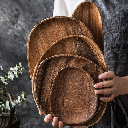 Natural wood tableware set with dishes and bowl, perfect for versatile home and hospitality use.