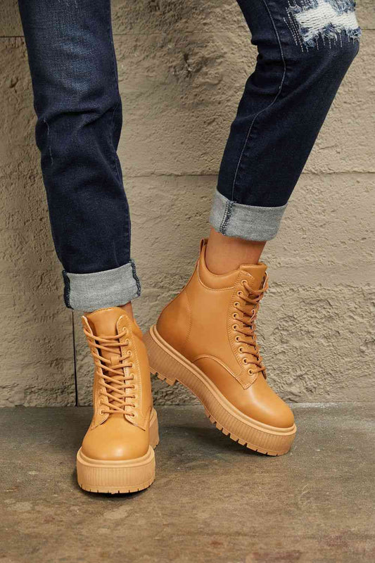East Lion Corp Platform Combat Boots with lace-up closure and round toe design, styled for chic urban and outdoor use.