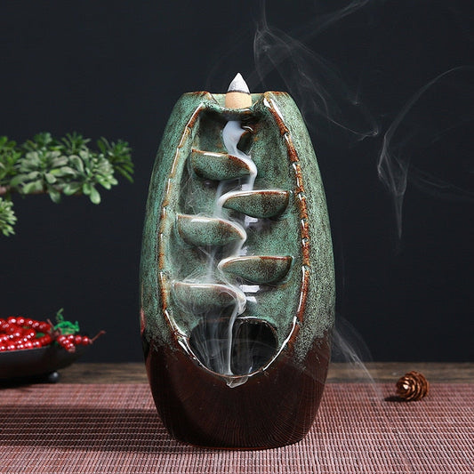 Ceramic Waterfall Incense Burner with creative interleaving blade design and aromatic smoke.